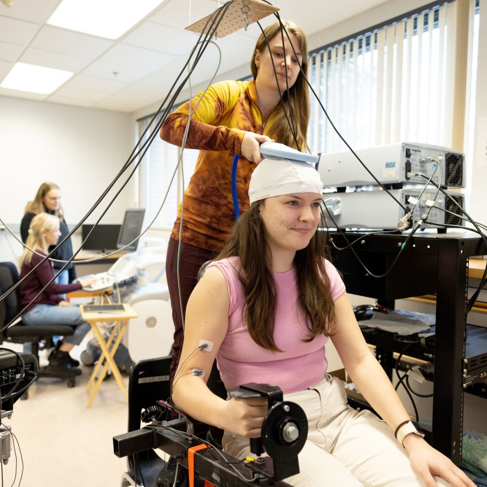 Student using a sensor over the head of another student in the lab