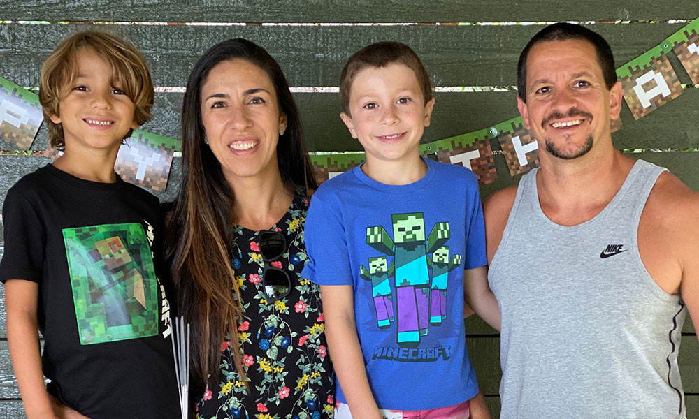 Barbara Oliveira, her husband and two sons